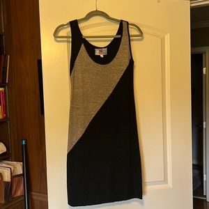Tan and black sleeveless, knit cocktail dress.